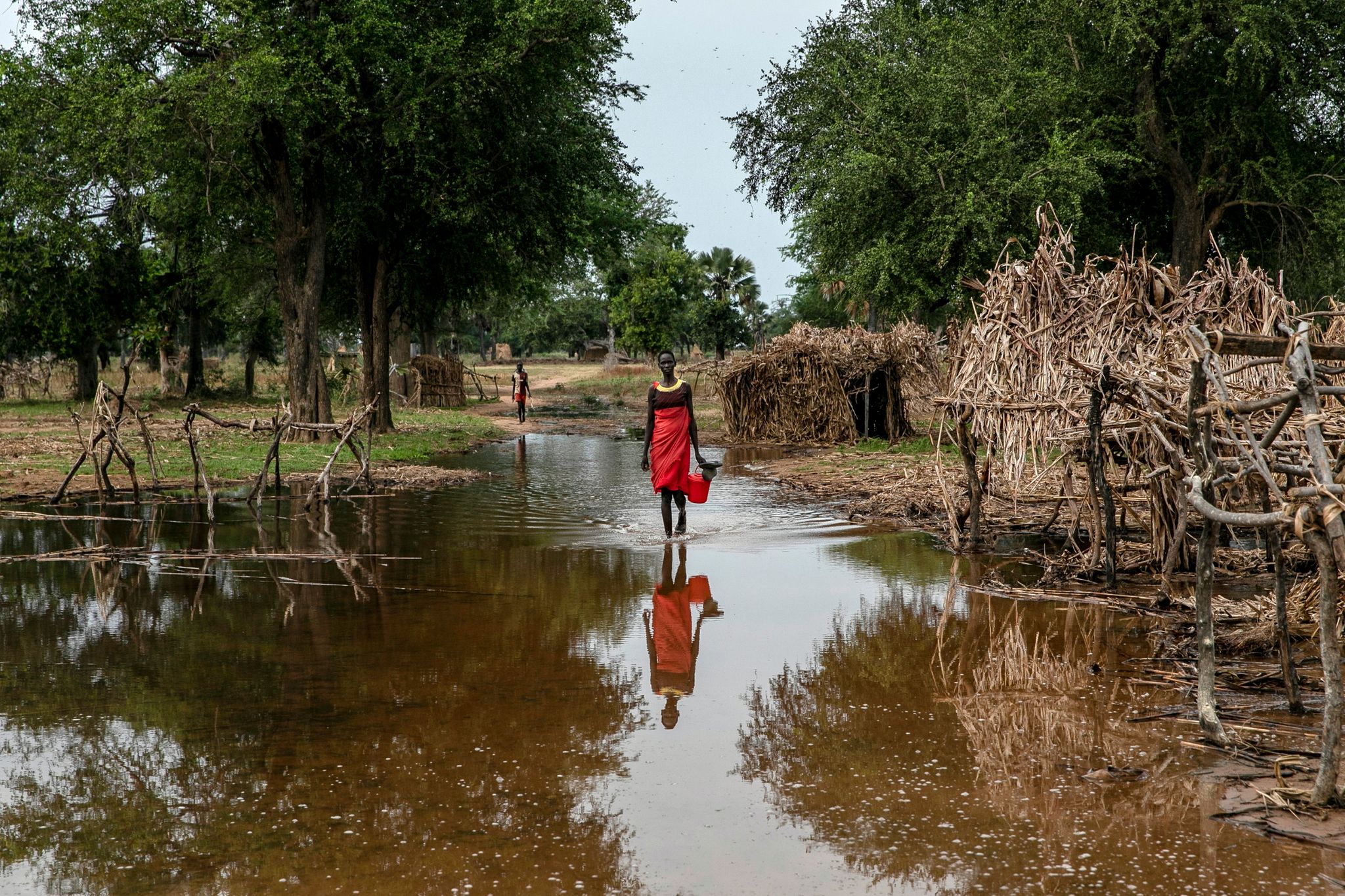 Eine Frau watet durch das Hochwasser zwischen verlassenen Unterkünften im Dorf Majak Awar im Südsudan. Dort sind ganze Bundesstaaten überflutet. Sieben der zehn Klimakrisenherde, die die Nichtregierungsorganisation Oxfam in einer aktuellen Studie identifiziert hat, liegen in Afrika.