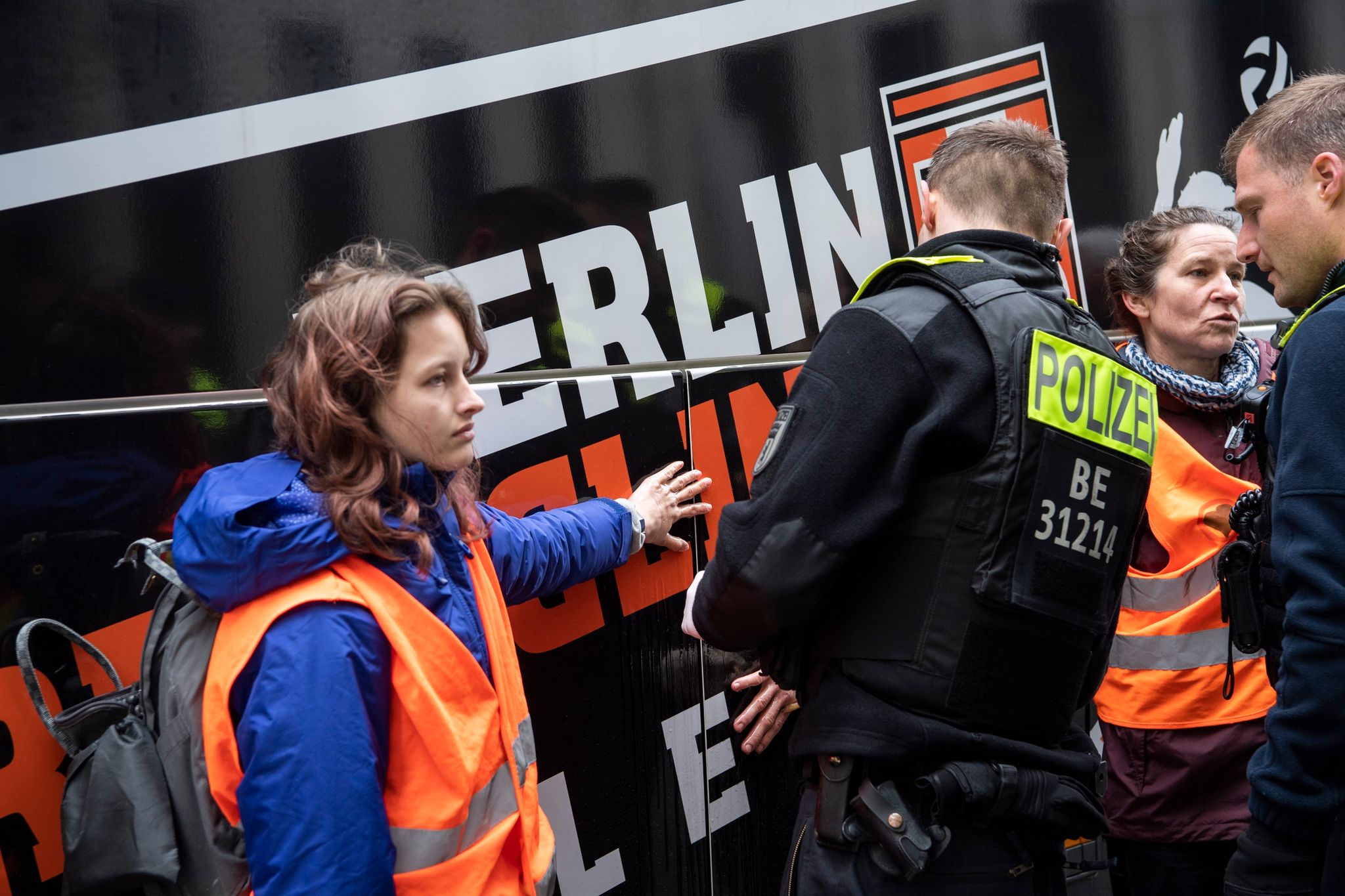 Zwei Klimaaktivisten haben sich an einem Reisebus vor dem Marriott Hotel am Potsdamer Platz geklebt.